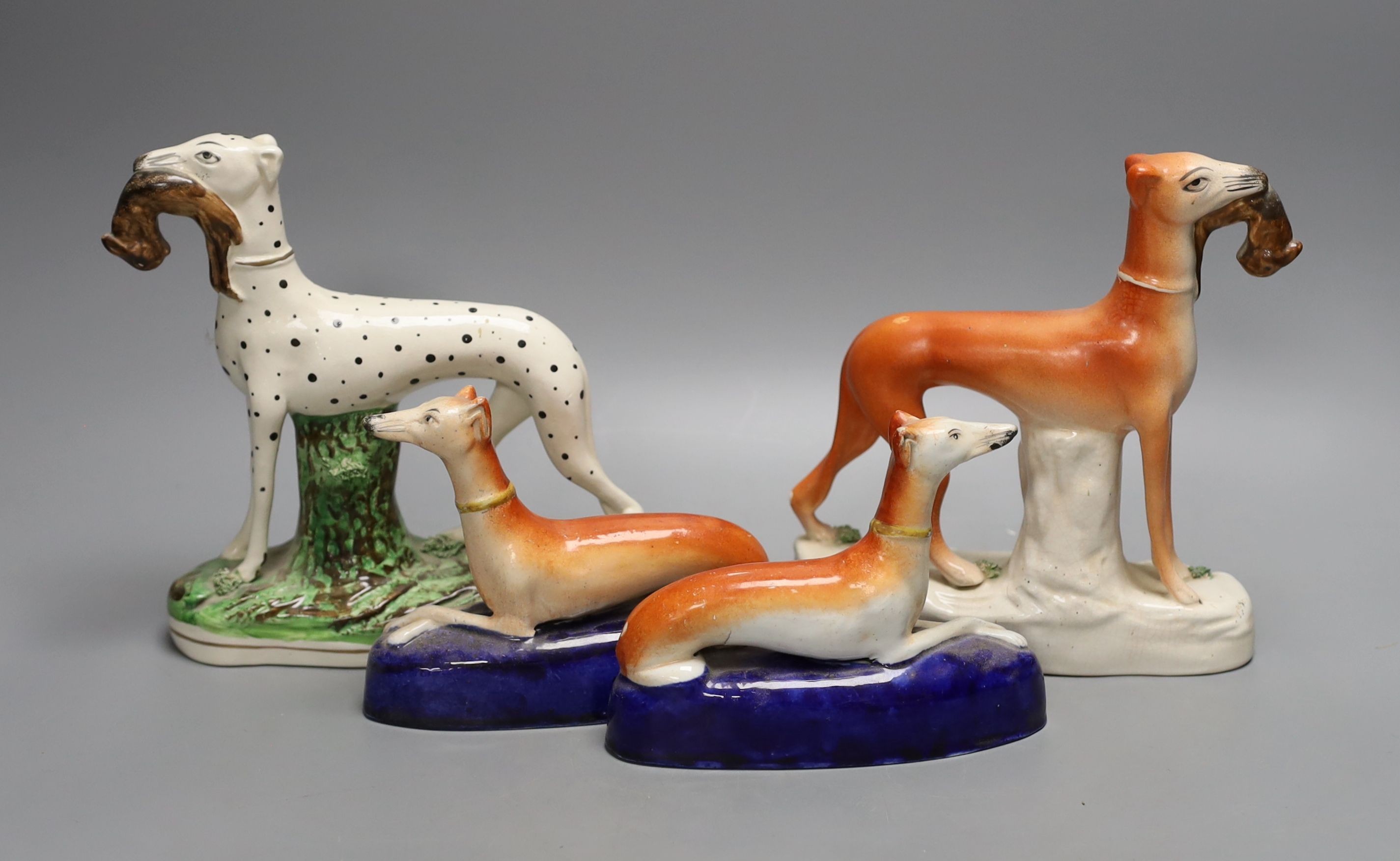 Two Staffordshire greyhounds and a pair of recumbent Staffordshire ‘greyhound’ desk stands. Largest 19cm